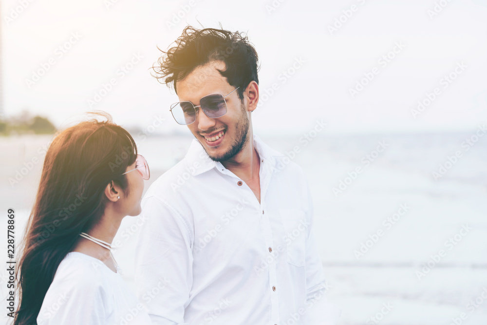 Couple going honeymoon on tropical beach in summer