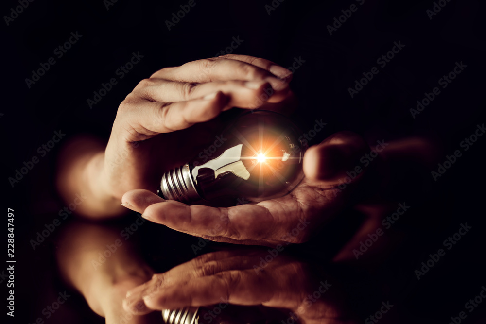 man hand choose glow light bulb creativity business ideas concept black background