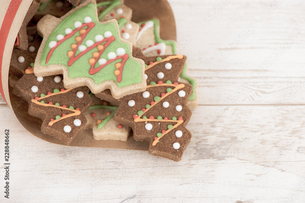 Tasty and cute baked Christmas cookies (gingerbread) with beautiful xmas decoration in paper bag on 