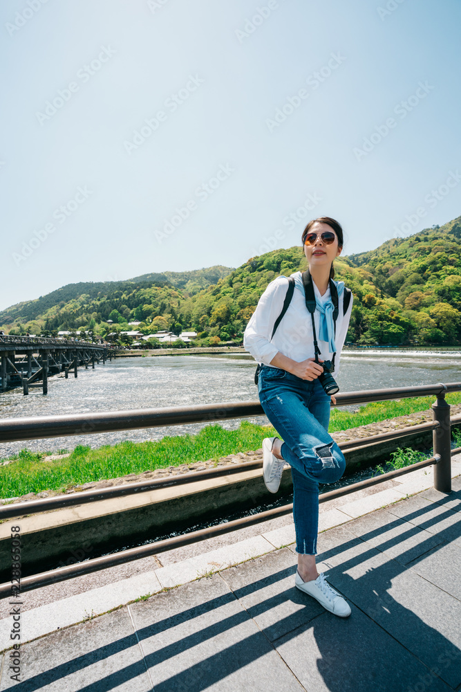 elegant traveler relaxing next to the river