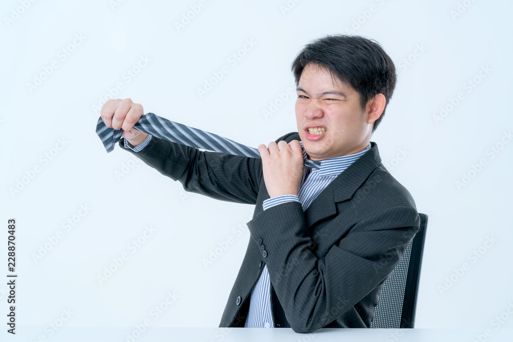 asian businessman try to solve big business problem hand pull necktie with emotion white background