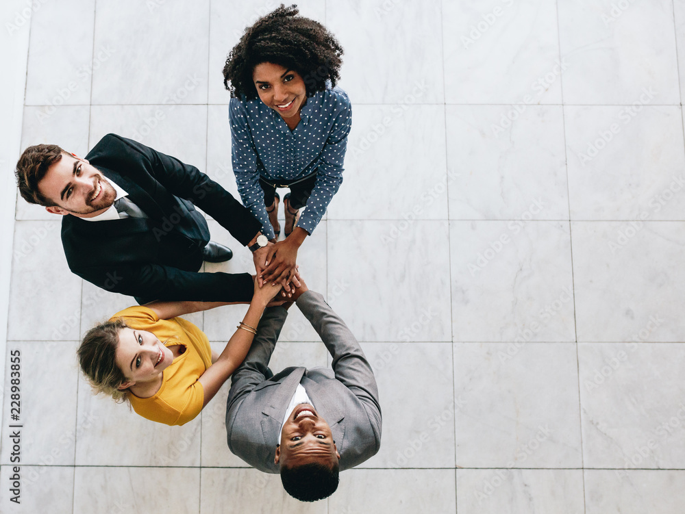 Multi-ethnic business team with hands stacked together