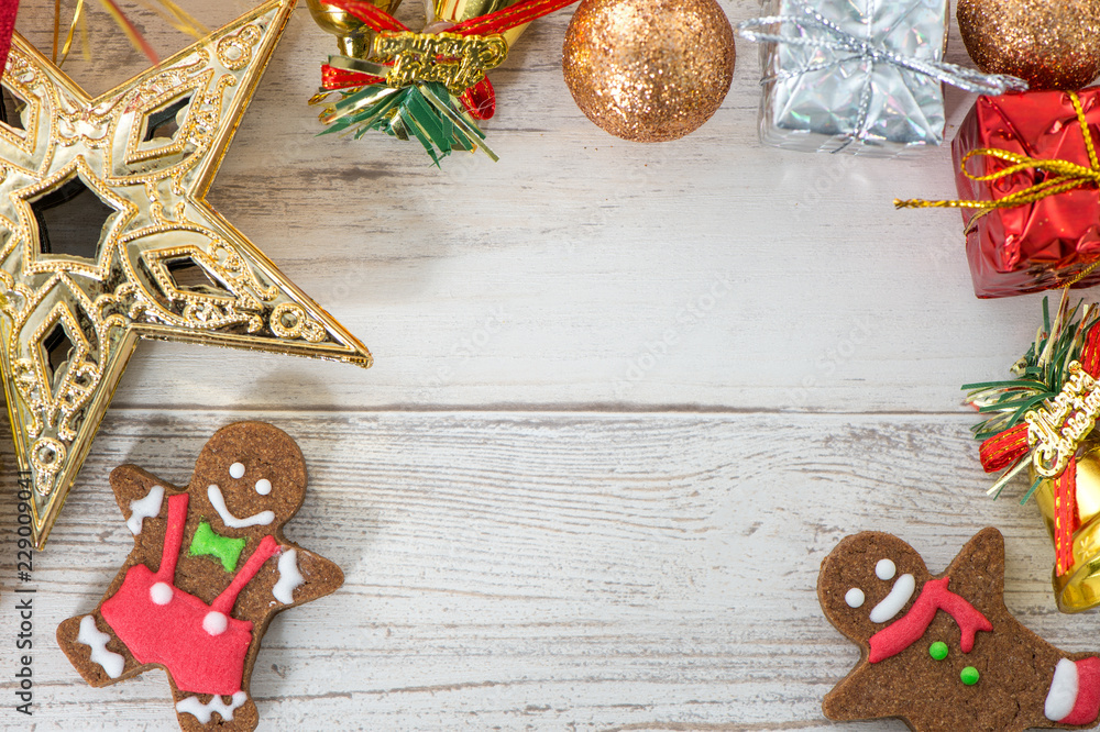 Beautiful Christmas composition and decoration with baked gingerbread man cookie on light wooden bac