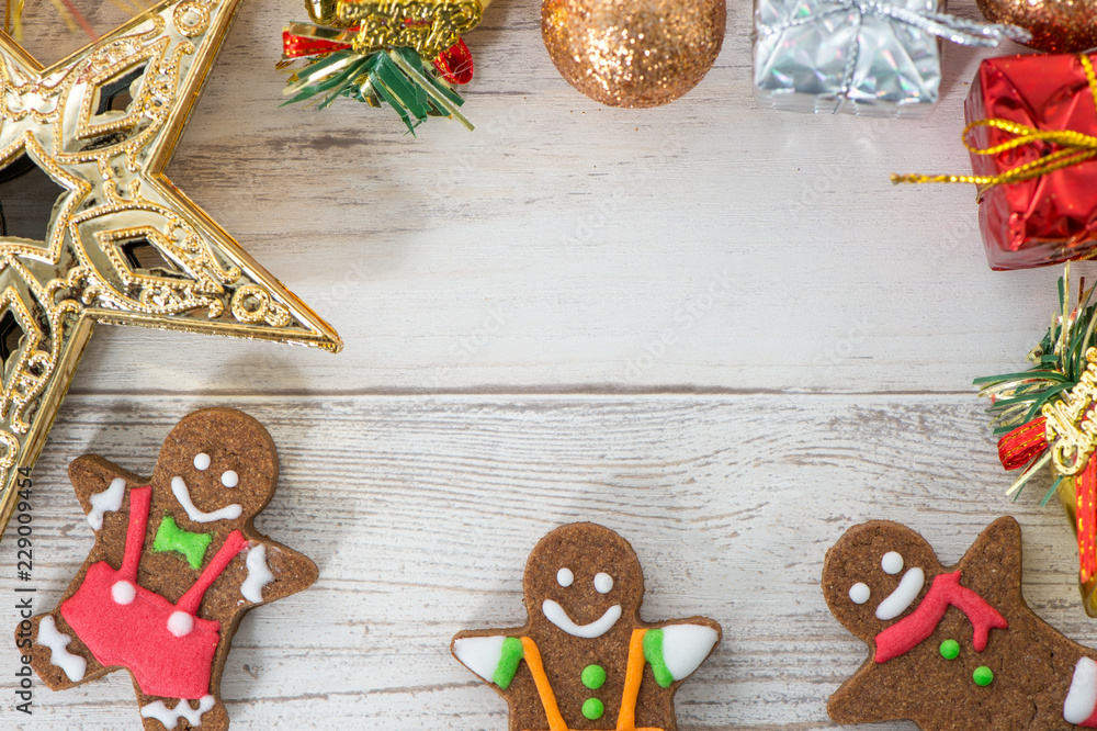 Beautiful Christmas composition and decoration with baked gingerbread man cookie on light wooden bac