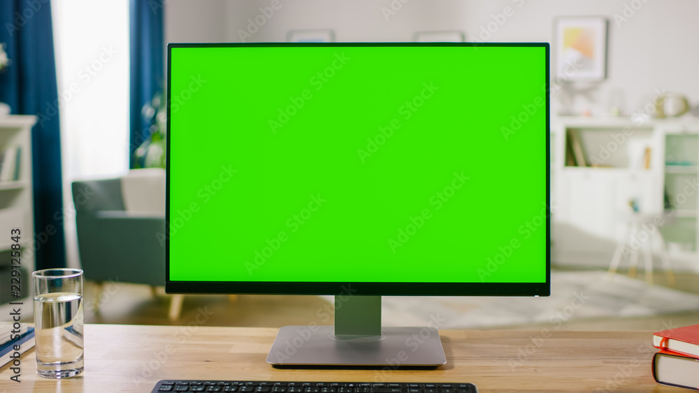 Personal Computer with Mock-up Green Screen Display Standing on the Desk in the Cozy Home Office Liv