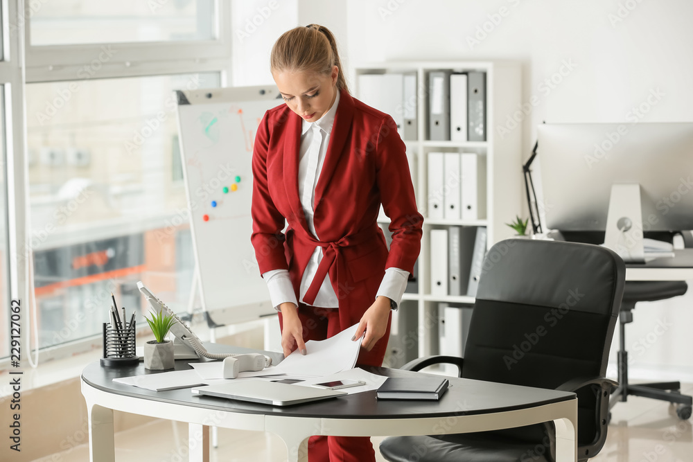 Beautiful female secretary working in office