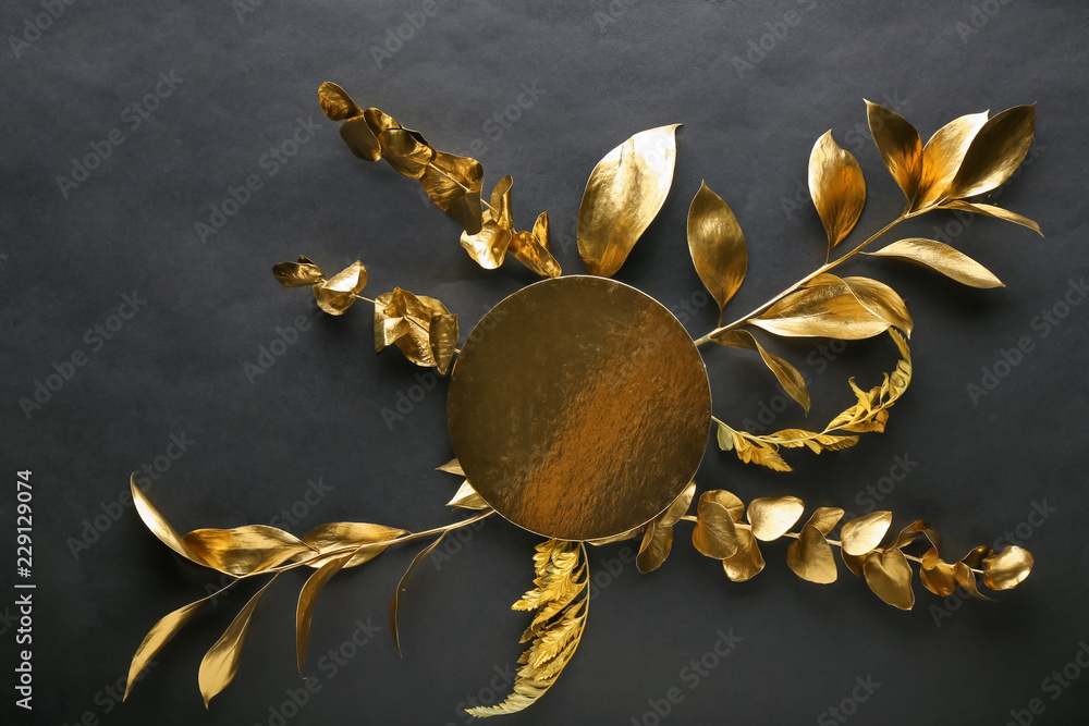 Golden leaves with greeting card on black background