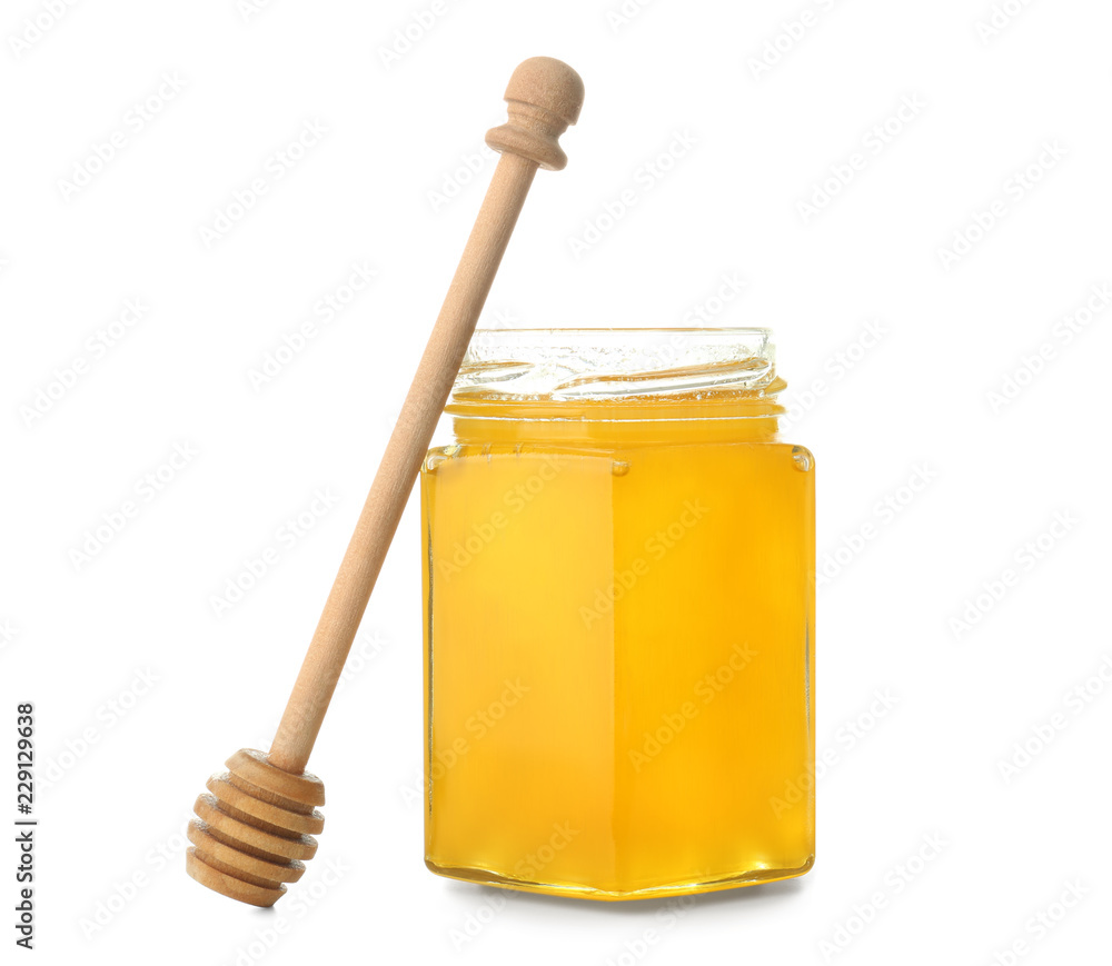 Jar of aromatic honey and dipper on white background