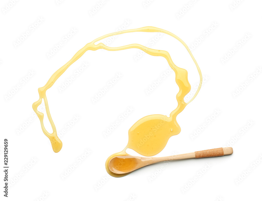 Wooden spoon and spilled honey on white background