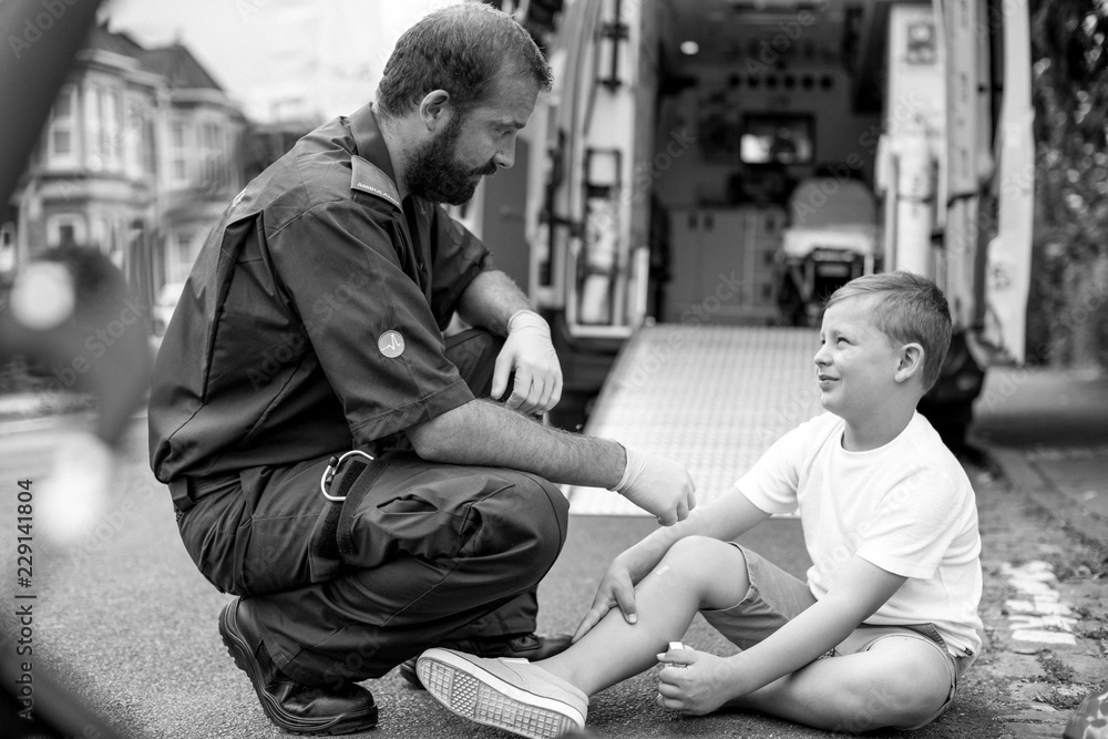 Injured boy getting help from paramedics