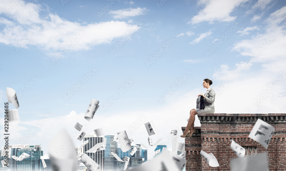 Businesswoman or accountant on brick roof against modern city sc