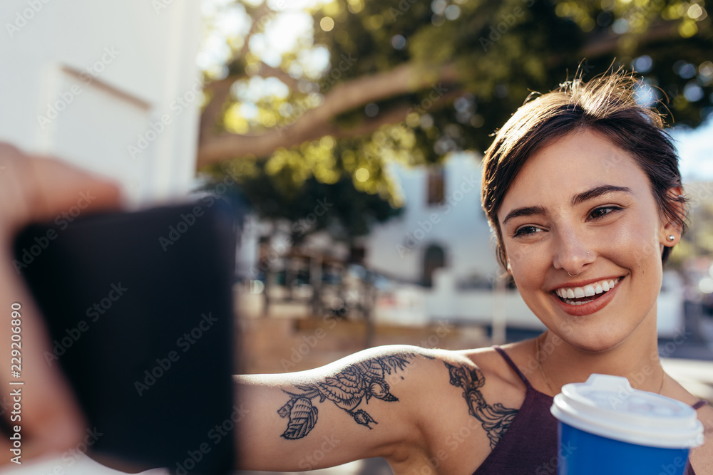 Vlogger taking selfie with her smart phone