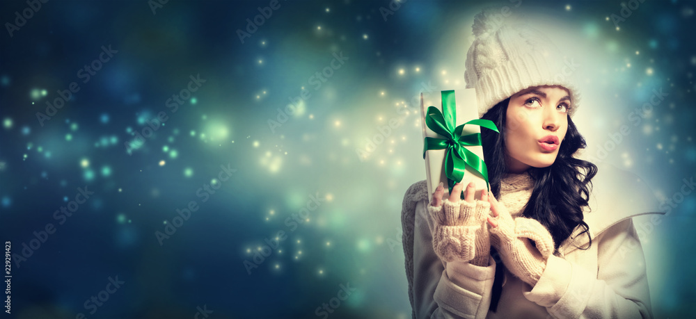 Young woman holding a Christmas gift box