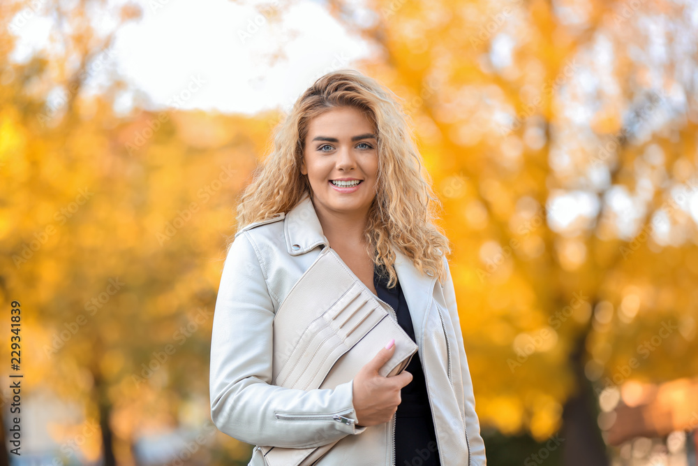 Fashionable young woman in park