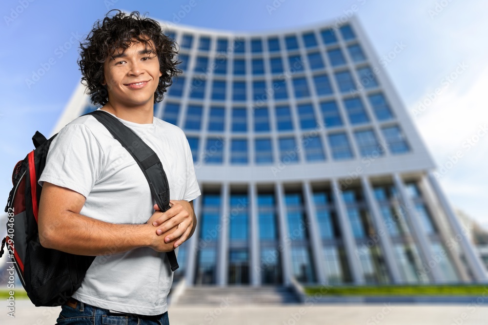 Smiling handsome boy student on  background