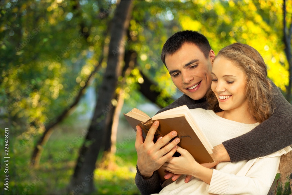 Happy Students reading a book in a