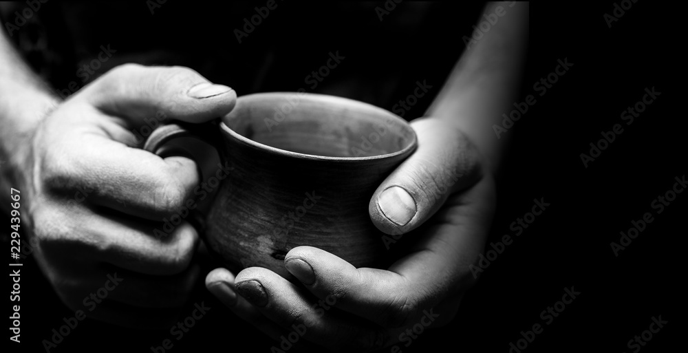 Hands of potter making clay pot, closeup photo