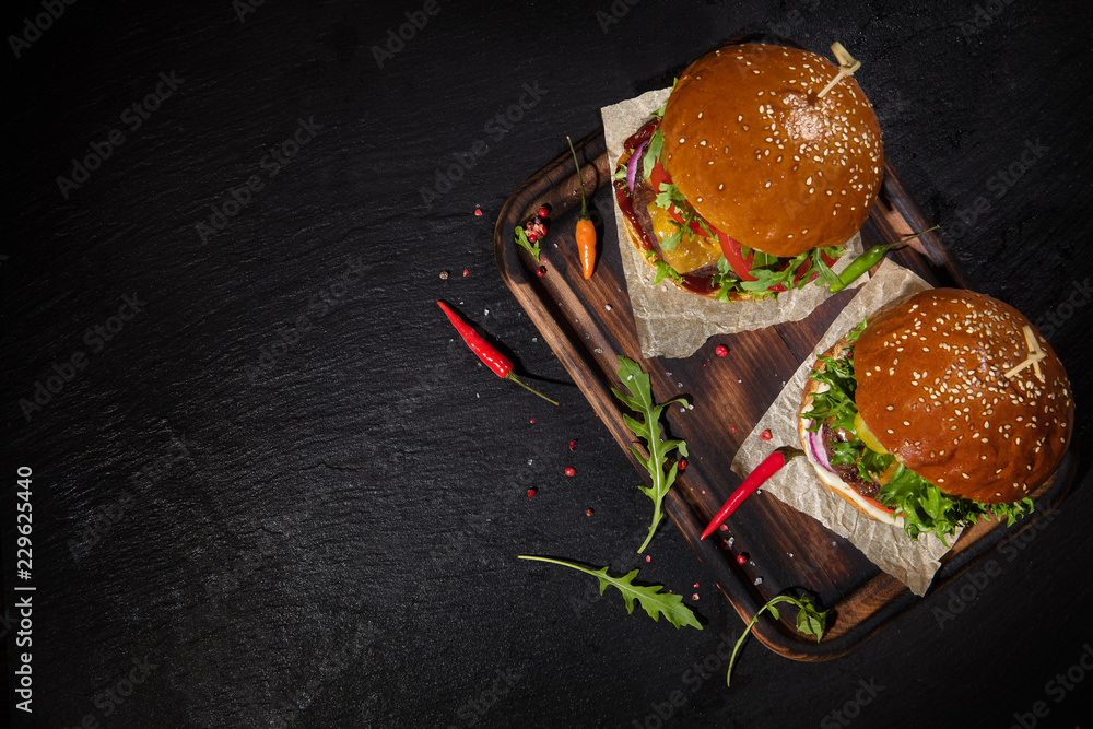 Delicious hamburgers, served on stone.