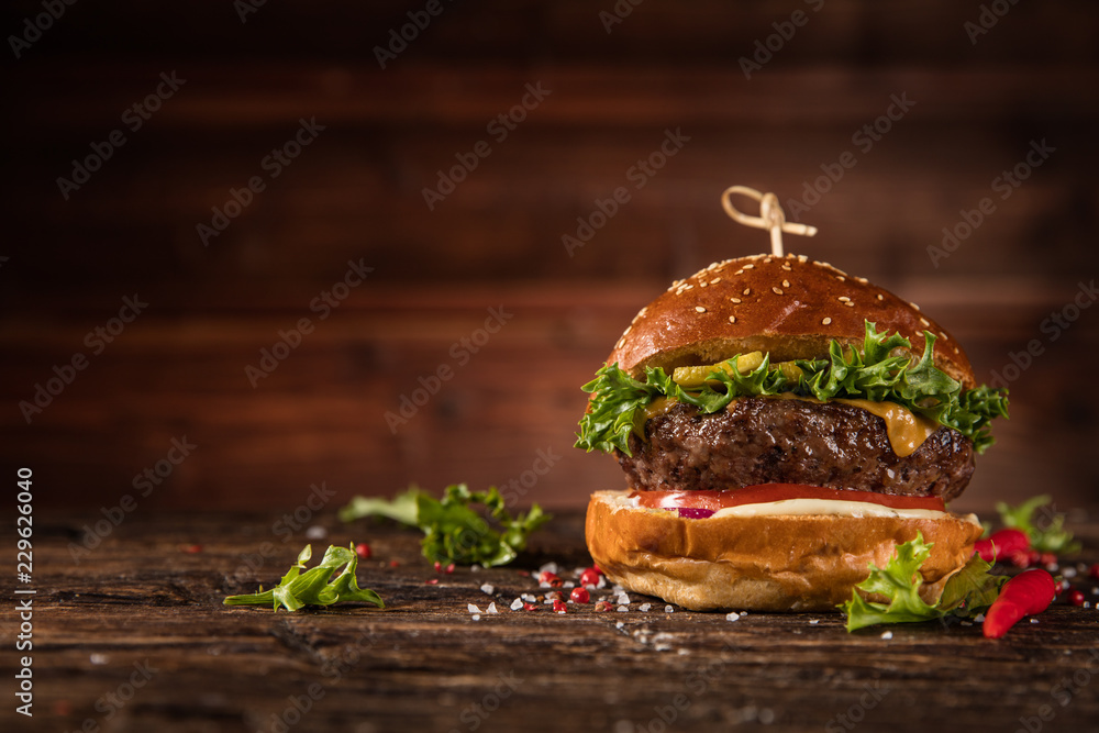 Delicious hamburger, served on wood.