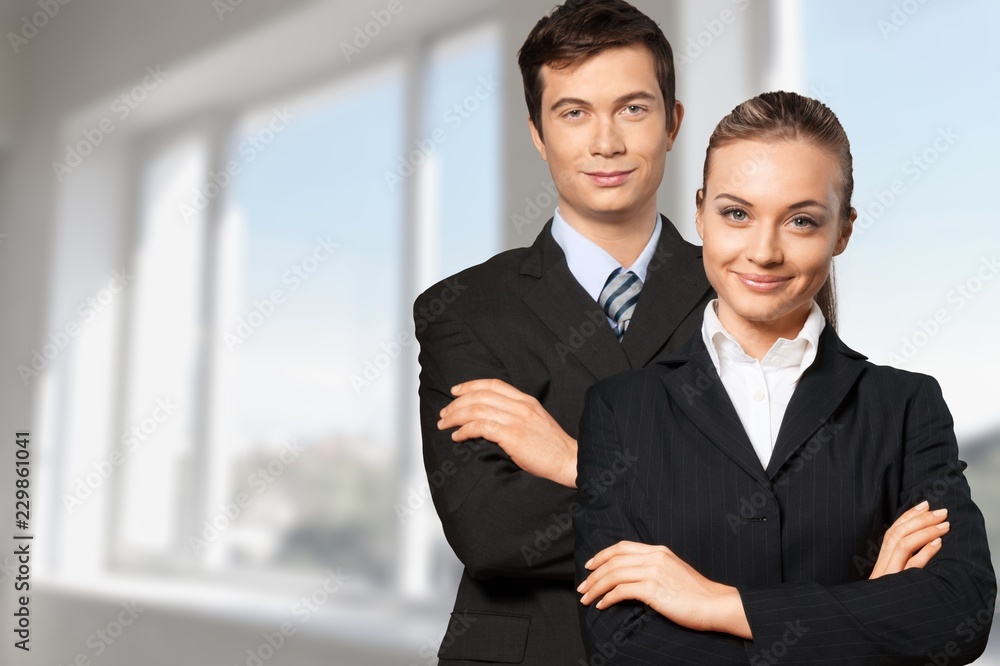 Young business couple in black suits in