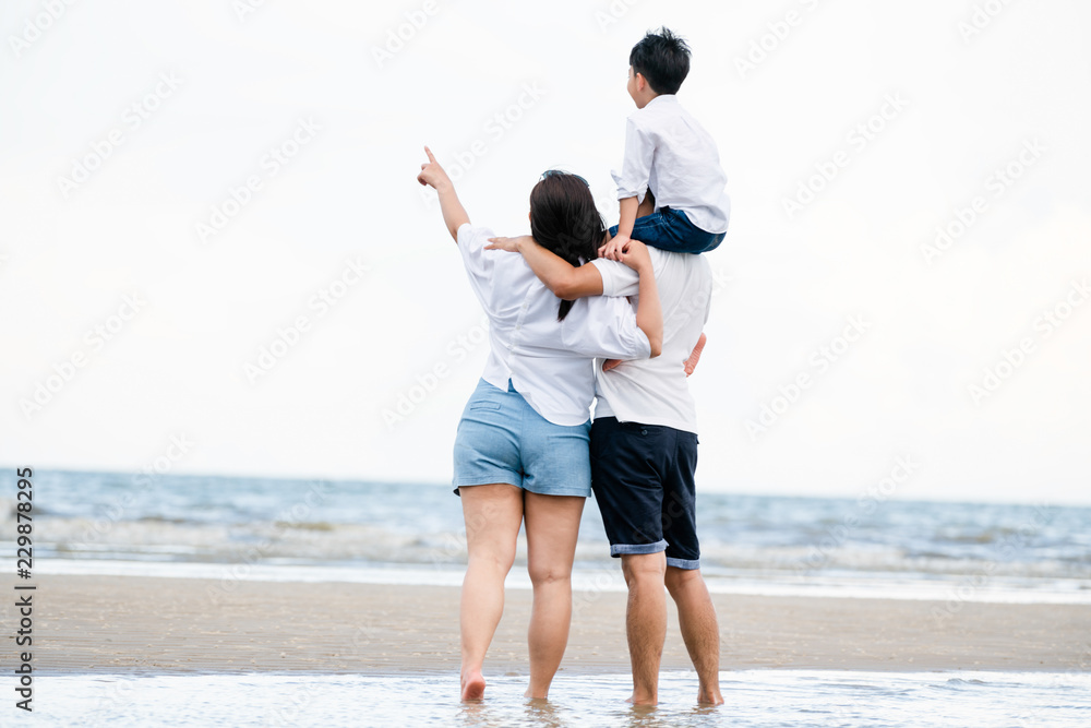 Happy family goes vacation on the beach in summer.