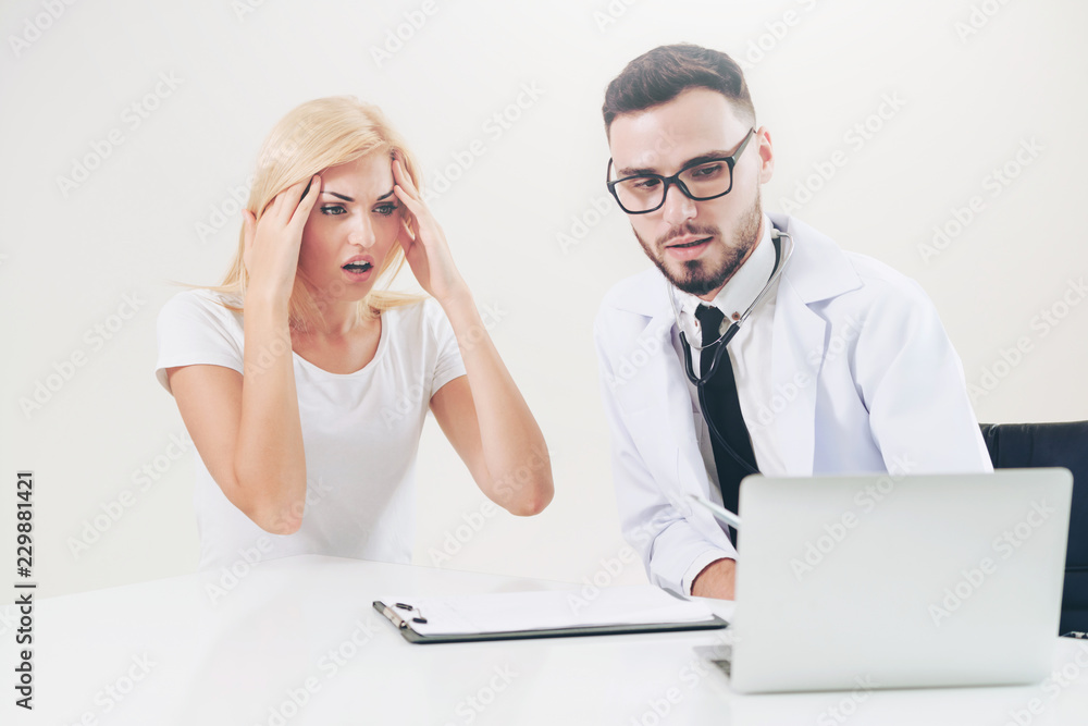 Male Doctor and Female Patient in Hospital Office