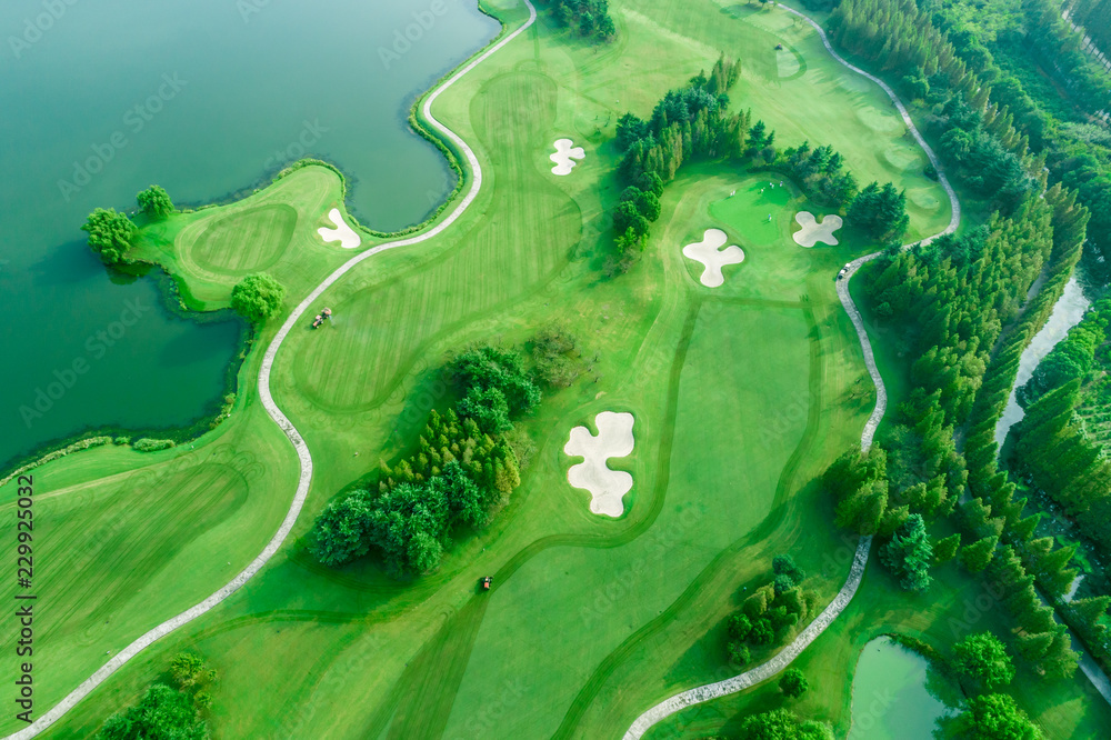 Aerial photograph of forest and golf course with lake