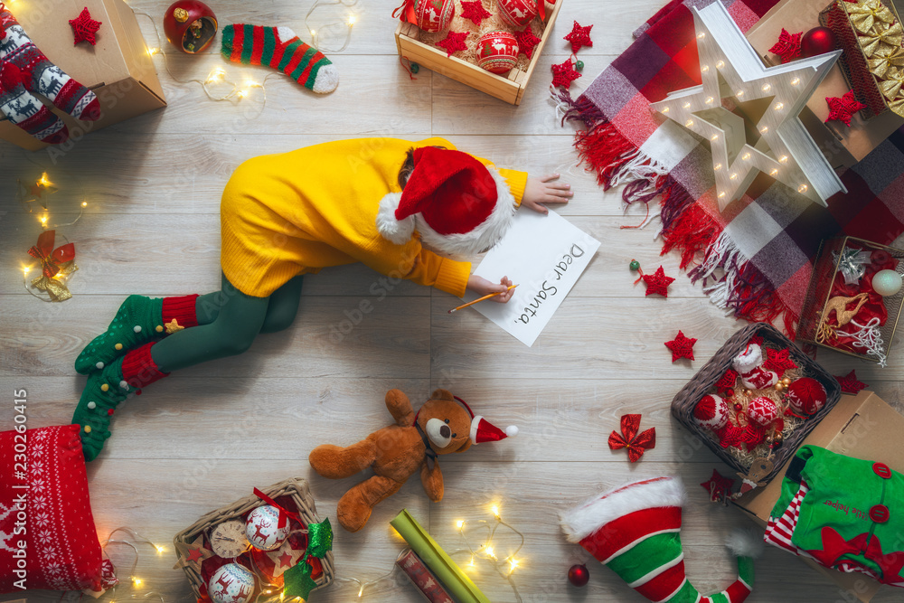 girl writing the letter to Santa Claus