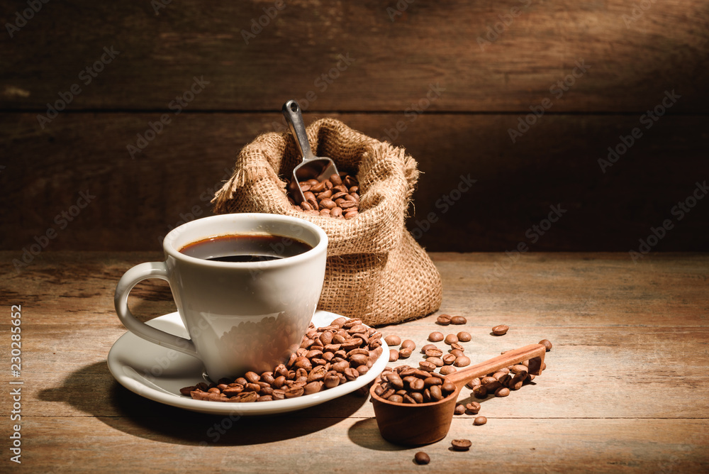 A cup of black coffee or americano with roasted coffee bean in bag, good coffee for health is black 