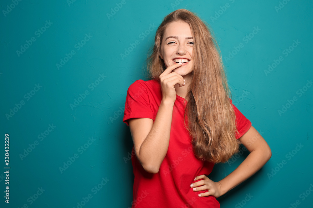 Portrait of happy young woman on color background