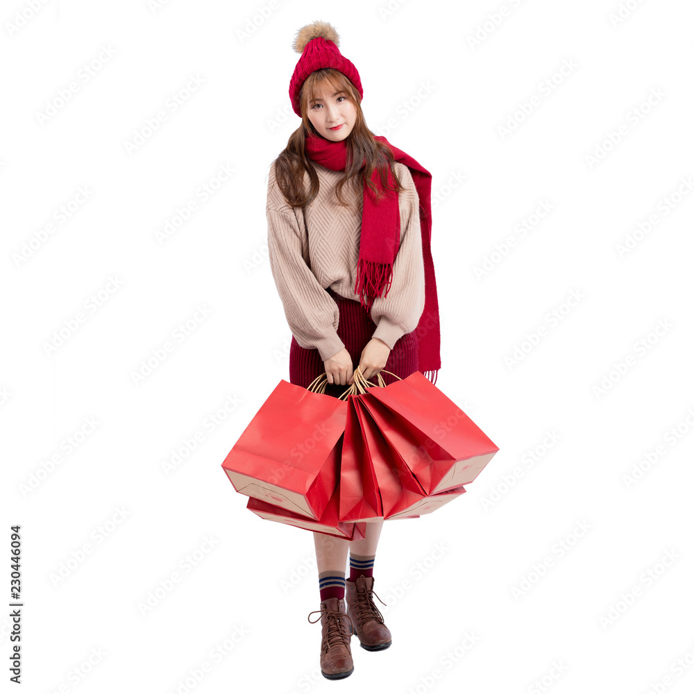 girl in santa hat with shopping bags isolated on white