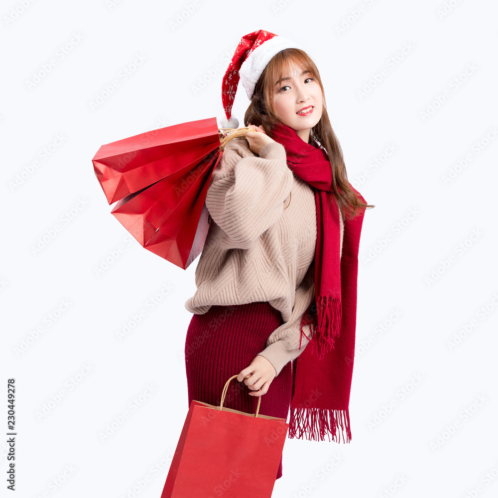 girl in santa hat with shopping bags isolated on white