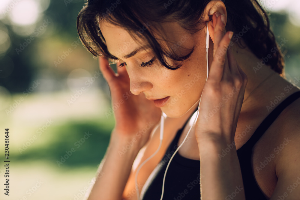 Fitness woman listening to music wearing earphones