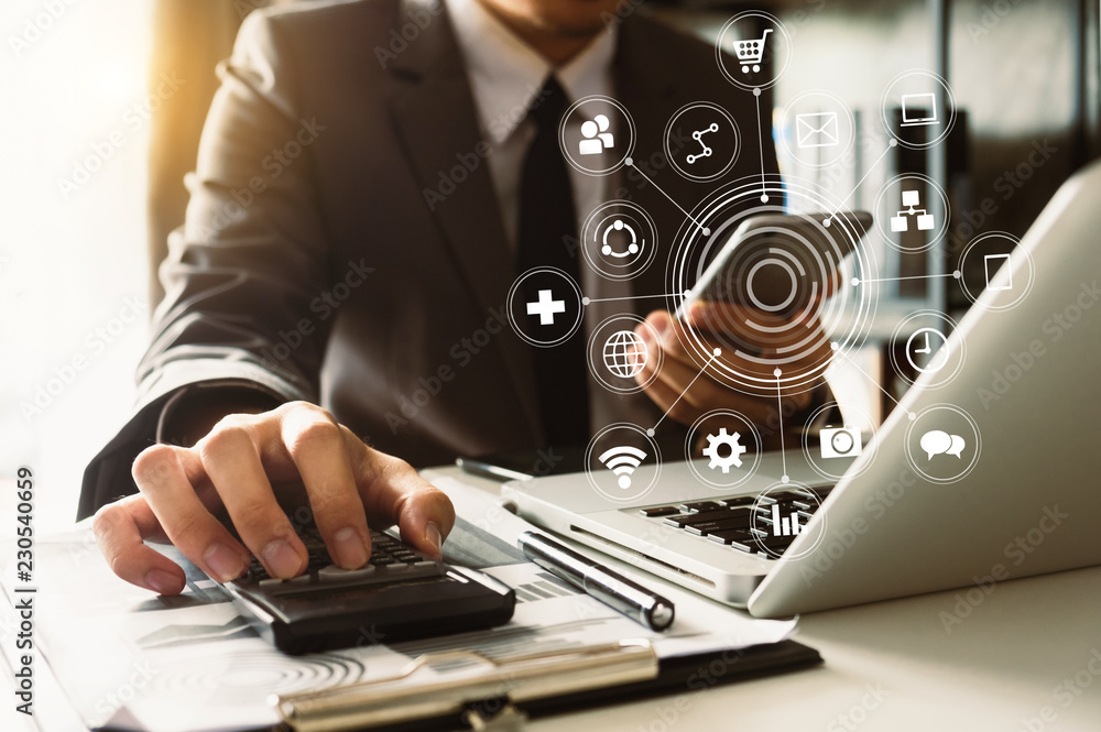 Businessman hands working with finances about cost and calculator and laptop with tablet, smartphone