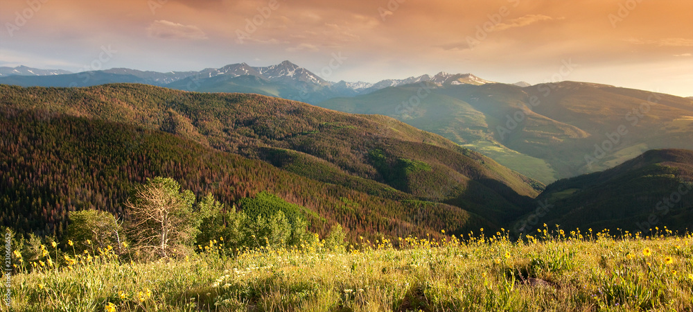 Beautiful sunset panoramic view of Colorado Rocky Mountain peaks from the Summit of Vail Colorados 