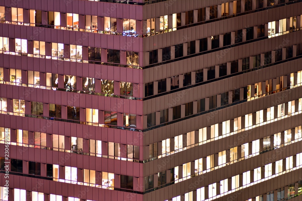 Office building at night. Late night at work. Glass curtain wall office building