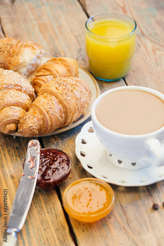 Black coffee and croissant with jam. Typical French Breakfast (Petit Déjeuner) background.