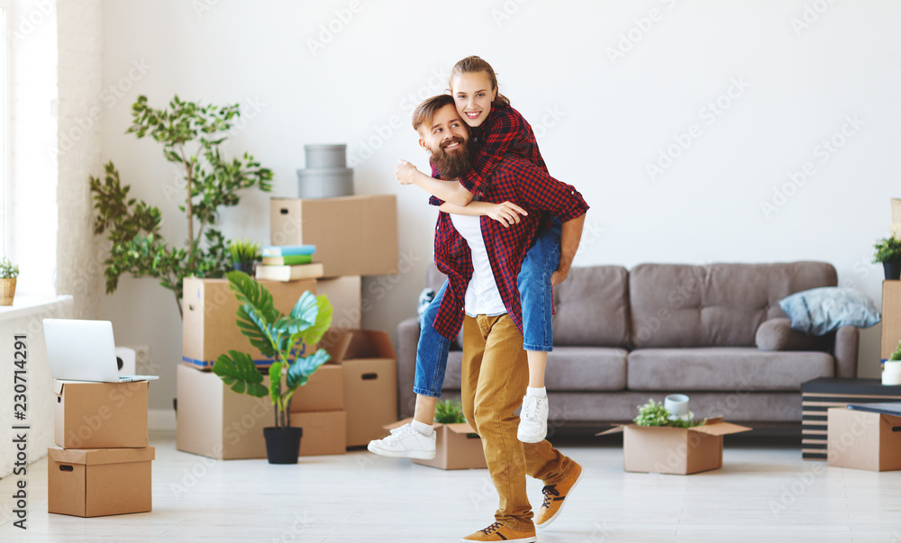 happy young married couple moves to new apartment