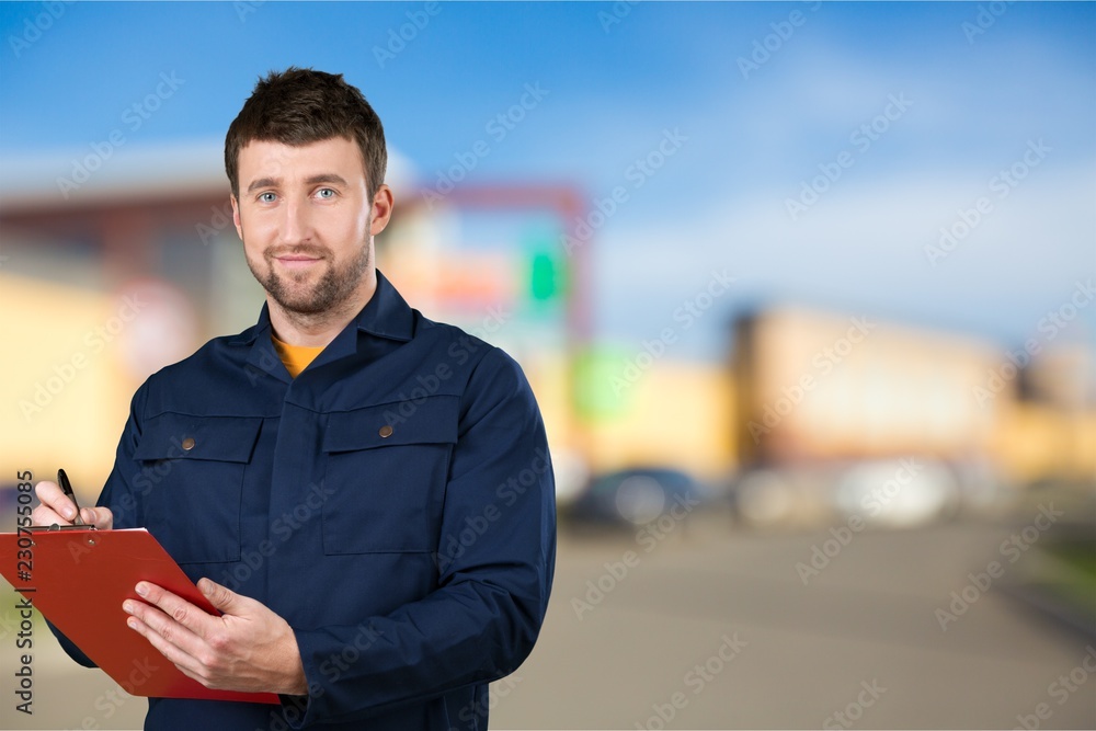 Portrait of cheerful Handsome  mechanic  on background