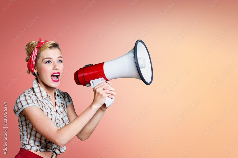 Portrait of woman holding megaphone, dressed in pin-up style