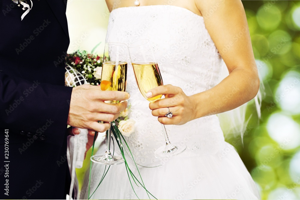 Bride and groom holding stylish bouquet during wedding ceremony