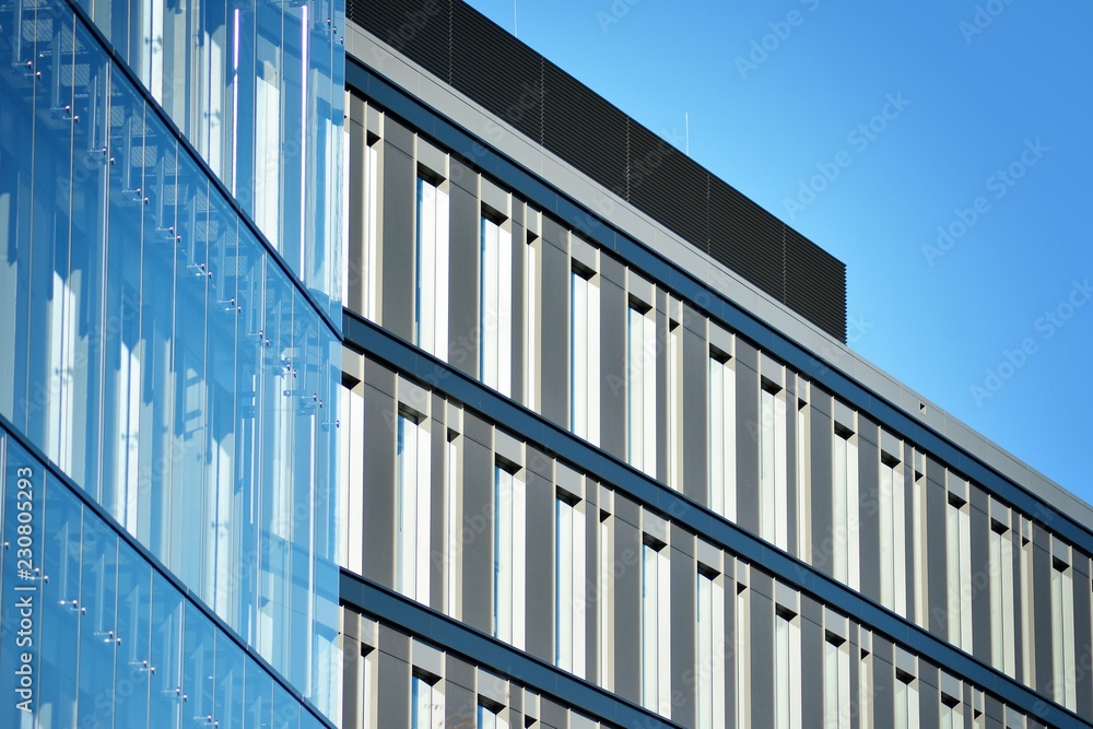 Modern office building facade abstract fragment, shiny windows in steel structure