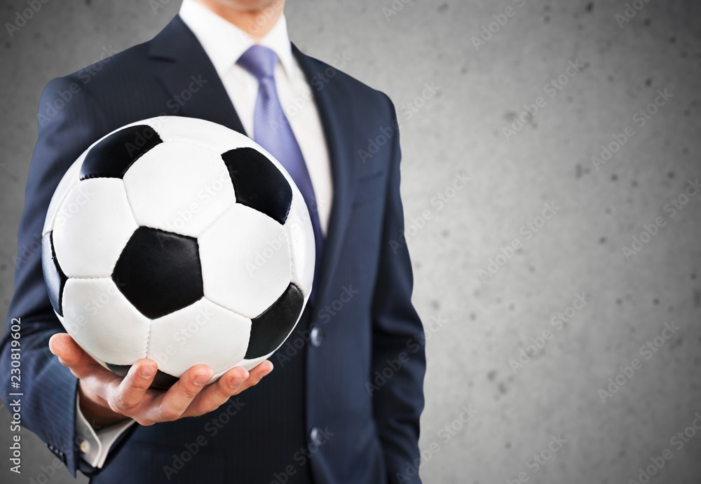 Close-up young male businessman holding Soccer ball