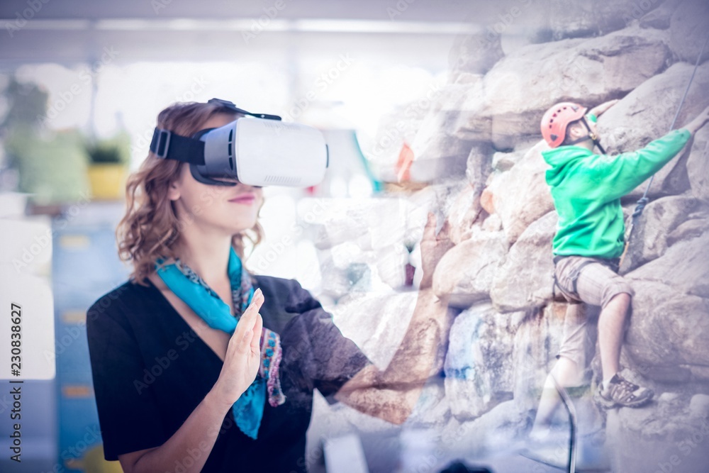 Composite image of female executive wearing virtual reality