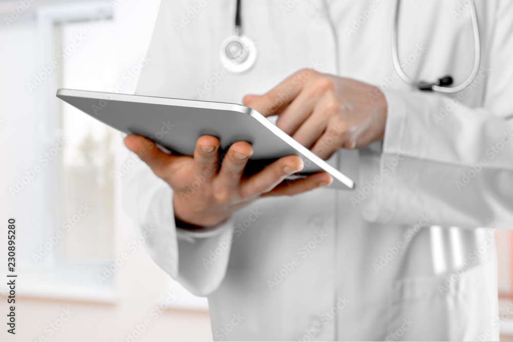 Close-up Doctor at hospital working with tablet pc