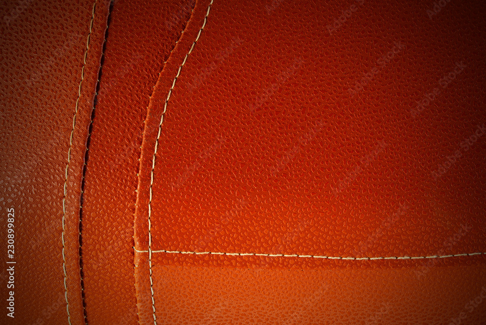 Orange leather with white stitch closeup for background.Part of leather motorcycle seat.