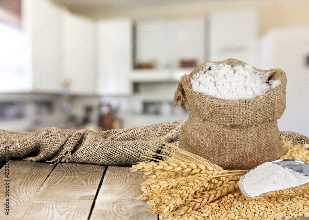 Sack of flour with wheat and scoop