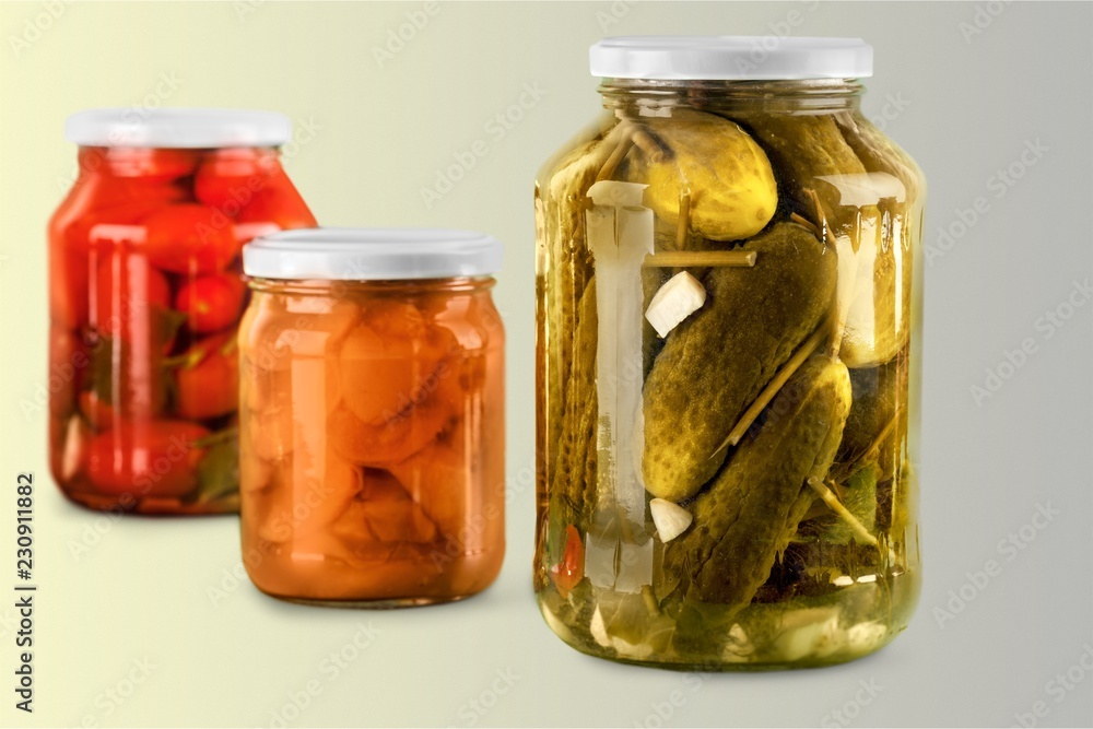 Jars with canned vegetables isolated on white