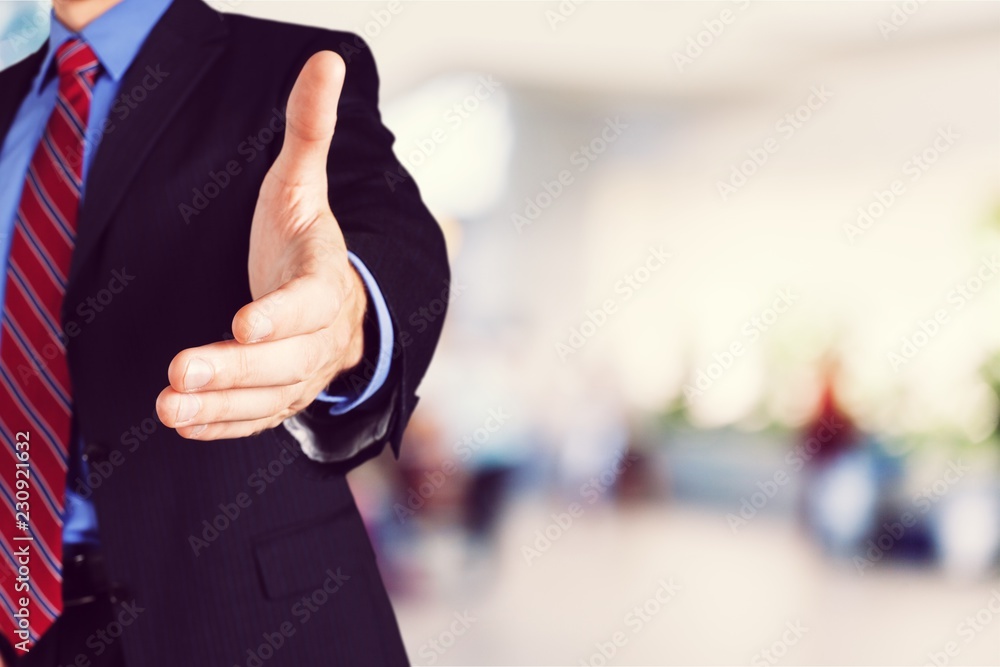 Man wearing a business suit reaching hand