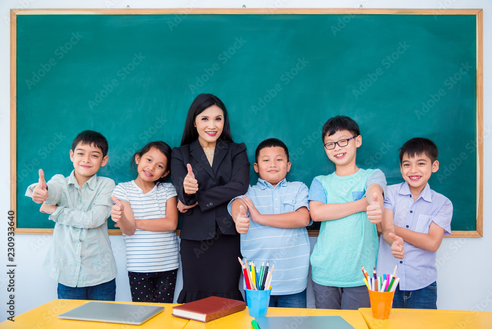 Group of happy asian student and teacher standing in classroom